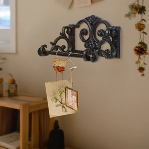 Vintage black cast iron wall mounted towel rack with European scroll design for home decor