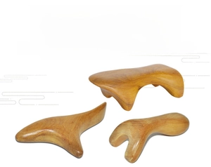 Three-piece sandalwood gua sha tool set featuring natural wood grain and polished finish