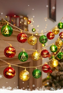 Detail of LED Christmas ball lights with gold, red and green plating on a fireplace mantel