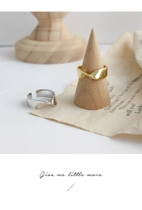 Detail of gold and silver Mobius rings with twisted design and polished finish