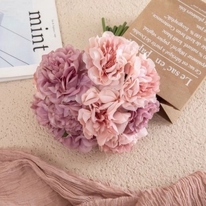 Flat lay of pink and purple silk hydrangea bouquet with artistic lifestyle props