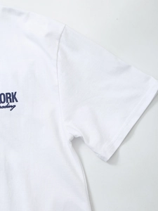 Detailed close-up of stitching on white cotton T-shirt sleeve with blue typography print
