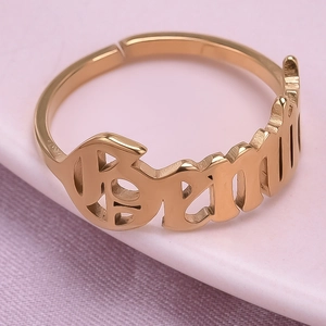 Macro shot of gold Gemini zodiac ring with artistic lettering and adjustable band