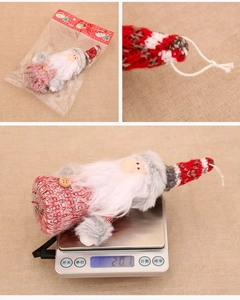 Detailed view of plush Christmas doll hanger with weight display and polybag packaging