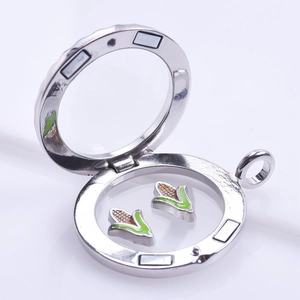 Polished silver floating locket with corn charms and magnetic closure on white background