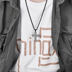 Men's two-tone stainless steel cross pendant necklace in black and silver on model