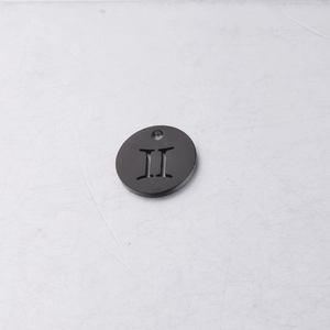 Macro detail of a black titanium steel 12mm round charm with Roman numeral II cutout