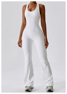 Detail of white flared yoga jumpsuit showing the racerback design and slimming leg silhouette