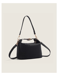 Detail of black woven leather shoulder bag with gold hardware and two removable straps
