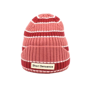 Striped knit beanie hat in red, pink and white with a rectangular fabric label