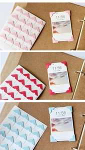 Detail showing colorful paper photo corner stickers applied to a DIY kraft scrapbook