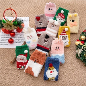 Detail view of thick winter coral fleece socks with cute 3D cartoon Christmas characters