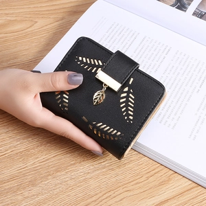 Women's short black leather wallet featuring leaf buckle and gold pendant detail