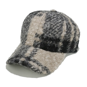 Close-up of thick textured sherpa fleece baseball cap with vintage plaid pattern detail