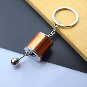 Detailed macro view of the brushed bronze and silver 6-speed manual gear shifter keychain