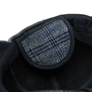 Detail of the warm wool plaid baseball cap showing the inner lining and ear flaps