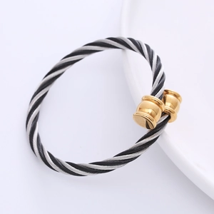 Minimalist steel cable twist bangle with silver wire and gold plated metal cylindrical tips