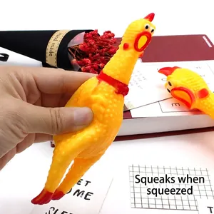 Classic yellow screaming chicken squeeze toy being squeezed to produce a loud sound