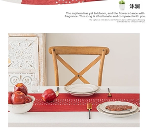 Detailed view of dark red table runner featuring laser-cut geometric triangle patterns