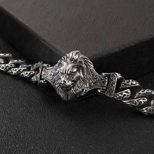 Macro shot of vintage lion head bracelet featuring detailed steel links and cuban chain