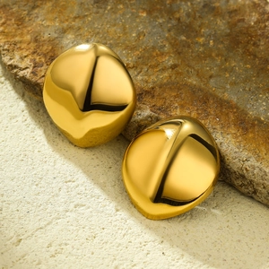 Polished 18K gold-plated irregular geometric stainless steel stud earrings on stone
