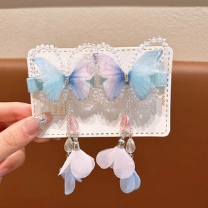 Detail of blue purple gradient butterfly hair clips with crystal beads and long tassels