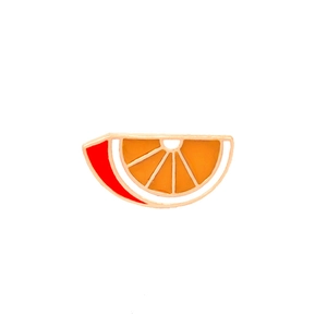 Detailed macro of a gold-rimmed orange slice enamel pin with vibrant citrus fruit texture