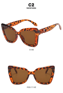 Detail view of cat eye sunglasses with leopard print frames and chain temple accents