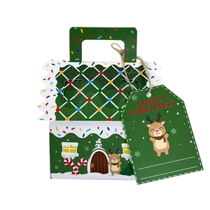 Detail of green gingerbread house Christmas gift box with Merry Christmas tag
