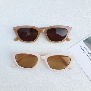 Stylish triangle cat-eye sunglasses in tortoiseshell and cream finishes on white surface