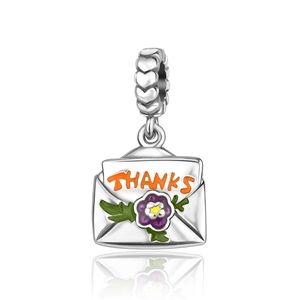 Close-up of silver envelope pendant with THANKS engraving and purple flower detail