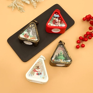 Close-up of vintage triangular Christmas lanterns in red and white with festive patterns