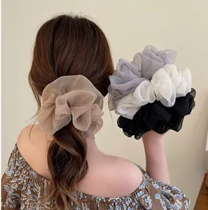 Detailed view of oversized layered organza hair scrunchies in four elegant classic colors