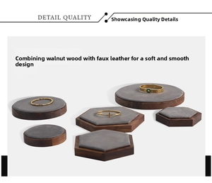 Detail of walnut wood and microfiber display bases for rings and luxury jewelry