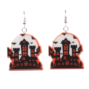 Detail of Halloween drop earrings featuring spooky castle and bat motifs on acrylic