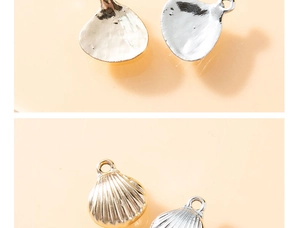 Detailed macro view showing gold and silver scallop pendants with smooth and ribbed textures
