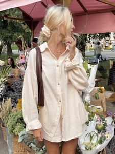 Women's cream two-piece lounge set with long sleeve button shirt and matching shorts