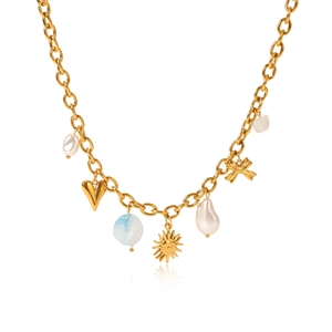 Detailed shot of golden charm necklace with baroque pearls, starfish and colorful beads