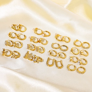 Set of 18K gold stainless steel hoop earrings with pearls and zircon on silk background