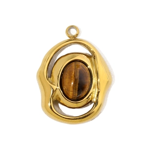 Macro detail of oval tiger eye stone pendant with textured gold stainless steel frame