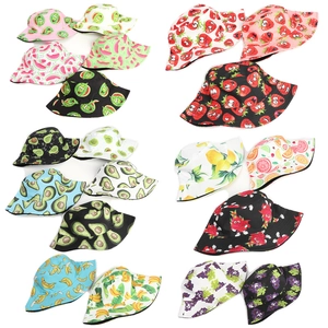 Variety of double-sided bucket hats with colorful fruit prints like watermelon and strawberry