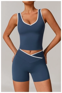 Detail of steel blue yoga set showing crossover high waist shorts and V-neck tank top
