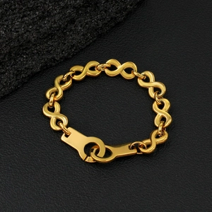 Macro detail of 18K gold stainless steel bracelet with infinity links and cuff clasp
