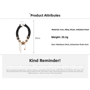 Detailed view of plush star tassel necklace with metal charms and faux pearl accents