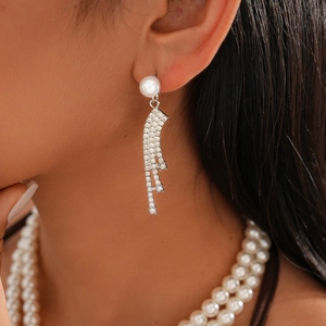Detail shot of elegant double-layered faux pearl earrings with sparkling rhinestones
