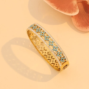 Macro shot of gold hollow flower bracelet with turquoise gemstones and clear rhinestones