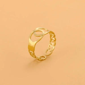 Close-up of golden geometric hollow ring with interlocking circles and chain details
