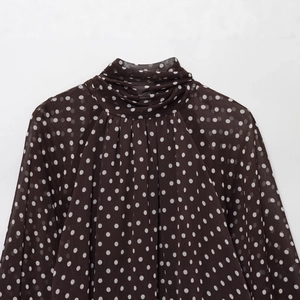 Deep brown polka dot chiffon shirt featuring a high ruffled collar and sheer fabric texture