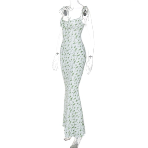 Close-up of floral print summer dress featuring green flowers and elegant tie straps