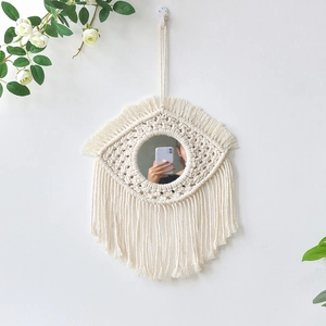 Nordic macrame wall mirror featuring eye shape design with cream cotton rope fringes